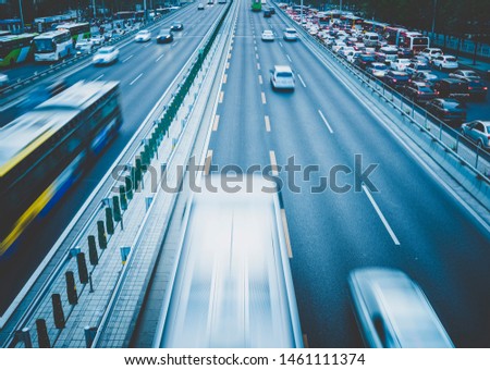 Cars on the highway are moving fast at night.