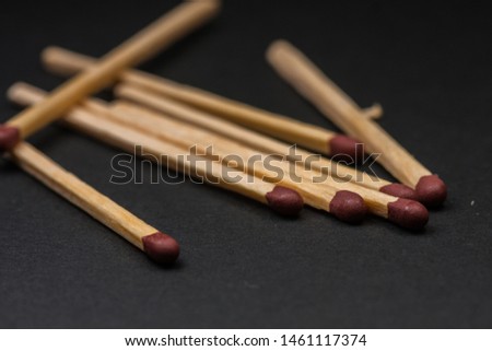 Match sticks accumulated on top of each other on a black background. Match sticks and black background. Royalty-Free Stock Photo #1461117374