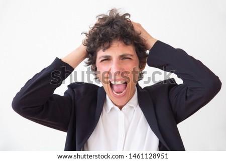 Emotional businesswoman screaming. Portrait of stressed middle aged businesswoman yelling and looking at camera isolated on white background. Emotion concept