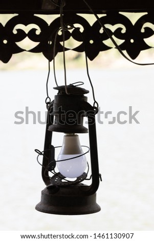 Retro style Lamp hanging on wood sculpture texture