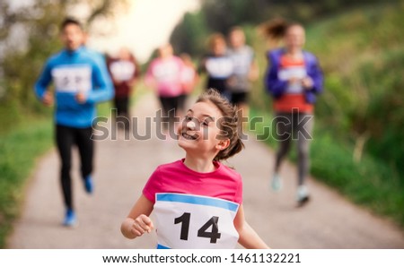 Large group of multi generation people running a race competition in nature. Royalty-Free Stock Photo #1461132221