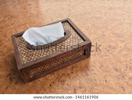 Local northern Thailand design of bamboo tissue box was made like an antique product on the beautiful wood textured surface background