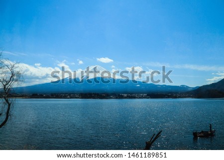Fuji Mountain with fisherman in boat Landscape view of Fujisan at  Kawaguchiko, Yamanashi, Japan.