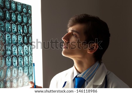 Image of male doctor looking at x-ray results