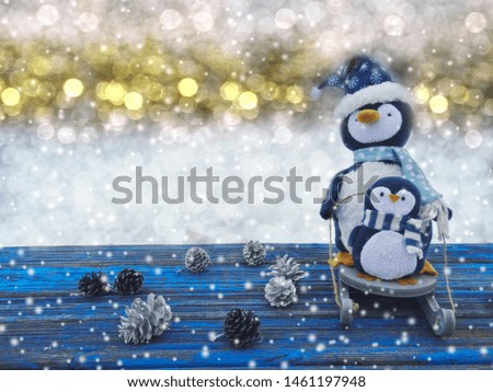 winter christmas background with penguin decor snow on blue wooden texture                              