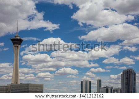 Las Vegas sky in a spring day.  Skyscrappers upper part and tower against blue sky with clouds background, Nevada state, US of America Royalty-Free Stock Photo #1461212162