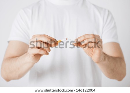 close up of man breaking the cigarette with hands