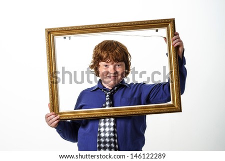 Freckled red-hair boy with picture frame. Isolated on white background.