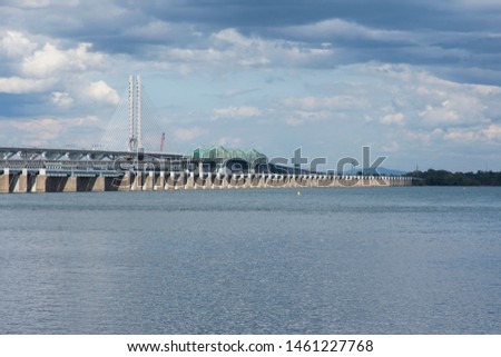 Horizontal view of the two Samuel-de-Champlain bridges over the St. Lawrence river with the south shore in the background during a beautiful summer day, Montreal, Quebec, Canada