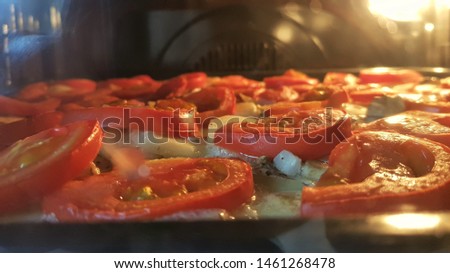 slices of tomato, potatoes, champignons baked in the oven, baking process
