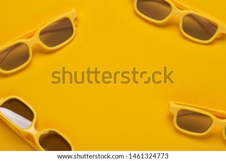 Flat lay yellow 3D cinema goggles for movie theaters