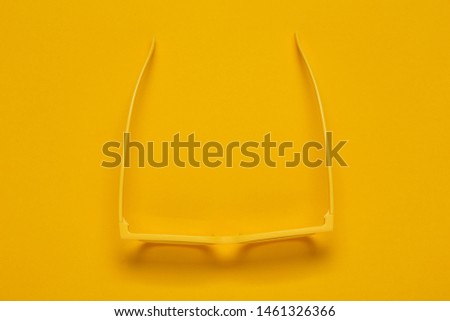 Pair of yellow cinema glasses for 3d movie theater, top view