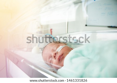 Little premature born child through hospital crib Royalty-Free Stock Photo #1461331826