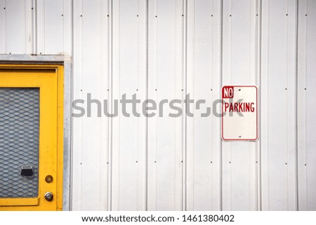  Yellow door and no parking sign                              