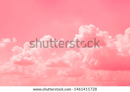 Pink sky background with white clouds.