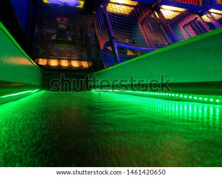 bright green light alley ball roll arcade game retro vintage win scoring gameplay on the background