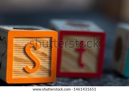 Wooden blocks for learning the english alphabet and numbers.