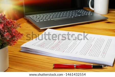 proofreading paper on table in office for service