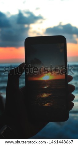 The atmosphere of the sunset that is immortalized through a mobile camera