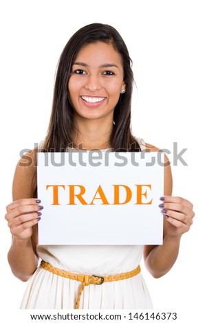A portrait of a beautiful smiling female holding a sign which says: trade. isolated on a white background 