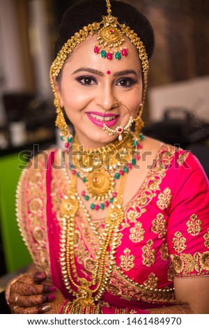 Beautiful indian woman Wearing Ethnic Traditional Outfit And heavy Gold Jewellery, wedding day, Gold loan concept. 