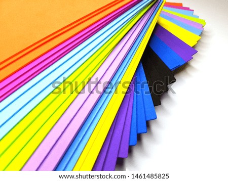 Colorful bright spectrum papers as an abstract background.  Flat lay with geometric shapes.