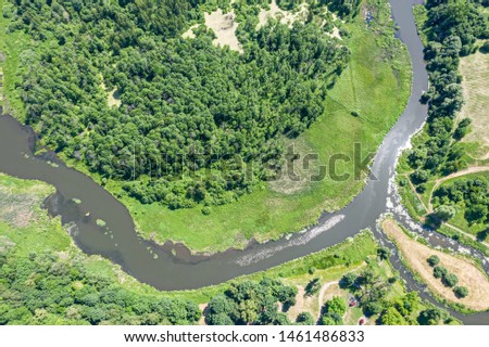 picturesque summer park scene aerial view with green trees, river and meadow