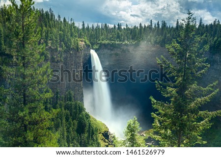 high Waterfall falling of cliff in a forest