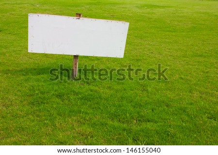 wood label sign in green grass