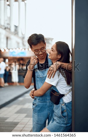Love and date concept. Young happy asian beloved man and woman embracing together while having fun together