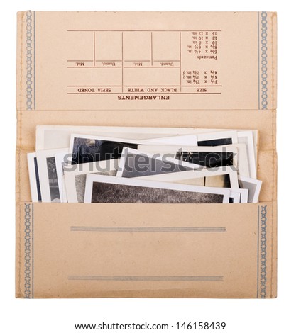 Old black and white photos in a vintage photo wallet isolated on white