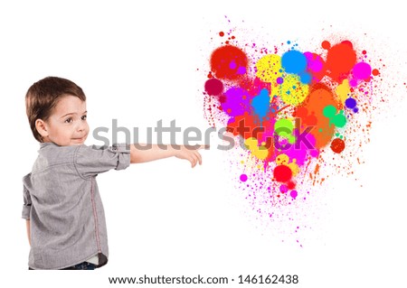  little boy shows his index finger on the color they painted heart. Symbol of love.