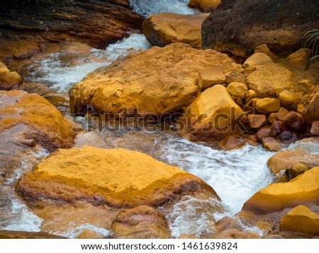 Smooth flowing water falling over rocks 