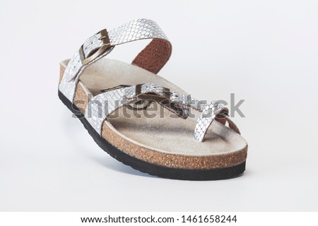 Female silver orthopedic slippers isolated over white background
