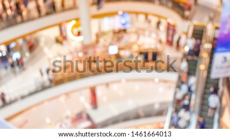 Close up blur of the interior department store and people to shopping scene background view. Abstract texture bokeh backdrop for fashion on sale with holiday. Top view of indoor zone. Supermarket.