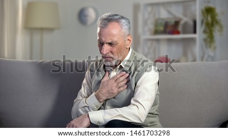 Pensioner suffering chest pain, heart attack, problems with breathing, asthma Royalty-Free Stock Photo #1461703298