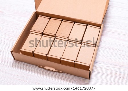 Lot of small cardboard boxes inside of large case with cover on 