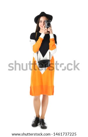 Teenage girl with photo camera on white background
