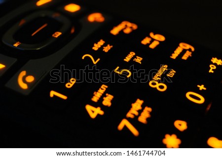 Glowing phone buttons in the dark closeup photo