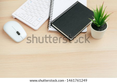 Business work place with equipment on wooden desk, top view