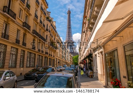France. Summer Paris. Sunny day. Many cars on the narrow street. Eiffel Tower in the background