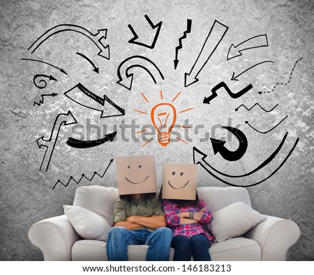 Smiling employees with boxes on their heads and sketches on the background