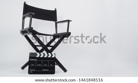 Black director chair with Clapper  
 board or movie slate use in video production or movie and film industry. It's put on white background. Royalty-Free Stock Photo #1461848516