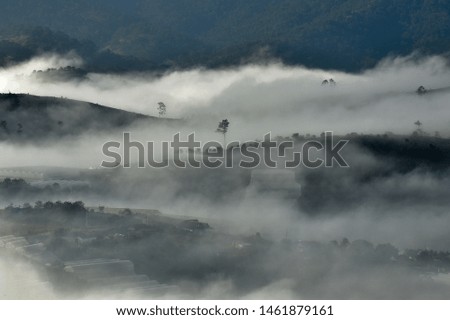 dramatic beauty landscape with magic fog and light cover small village in valley at the sunrise, photo used for advertising travel, magazine, printing and more