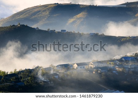 dramatic beauty landscape with magic fog and light cover small village in valley at the sunrise, photo used for advertising travel, magazine, printing and more