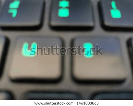 Blurred photos of keyboard with green back light. 