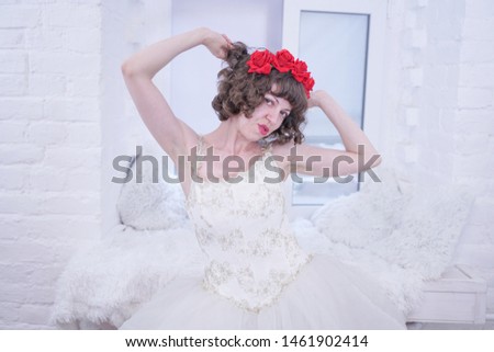 Adult fashion model wearing red roses on head and white wedding bride dress on white background.