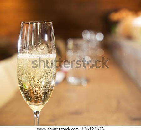 Glass of champagne on a blur background Royalty-Free Stock Photo #146194643