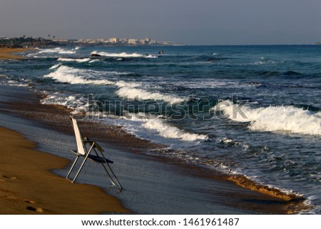 a chair stands on the shores of the Mediterranean in Israel