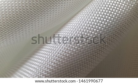 Fiberglass fabric. Abstract background. Fiberglass. Woven texture. Textured surface. Glass threads. Light fabric